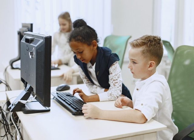 Two students coding together at a computer